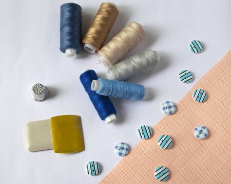 tools for sewing and needlework. hobby. multi-colored sewing thread. buttons
