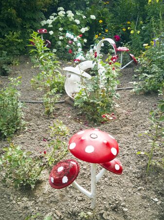 A flower from a plastic bottle. Mushroom from old pans. Swan from the bus. Decoration for the garden do it yourself. Reuse plastic. The decor of the waste.の写真素材