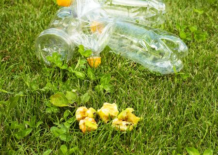 Plastic bottles lie on the green grass. Pollution of nature. Rubbish on the lawn.の写真素材