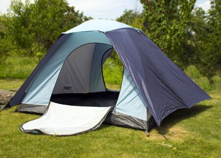 Blue tourist tent. Camping. Equipment for recreation and tourism.の写真素材
