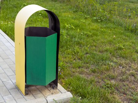 Trash can stands near the sidewalk. Environmental Protection. Trash can. Waste collection.の写真素材