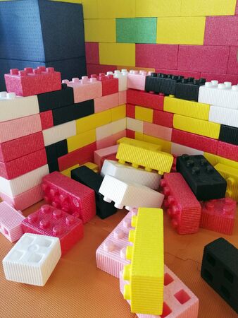 Large foam building blocks for a child s playroom. Multi-colored bright toys. Destky playroom. Entertainment for children. Childhood.の写真素材
