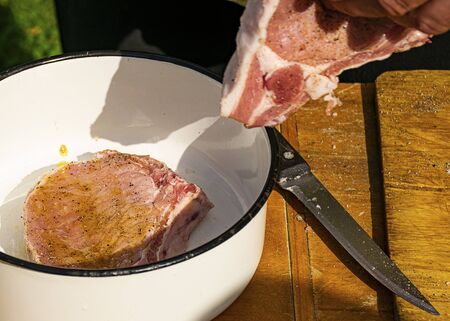 Cooking pork meat for barbecue. Pork with olive oil and spices. Raw pork steaks. Marinating meat. Rest at nature.
の写真素材