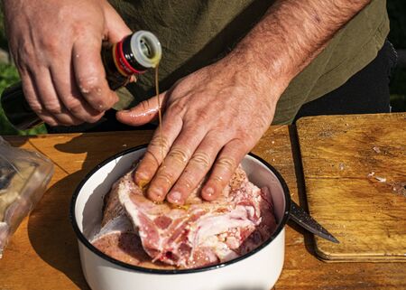 Cooking pork meat for barbecue. Pork with olive oil and spices. Raw pork steaks. Marinating meat.の写真素材