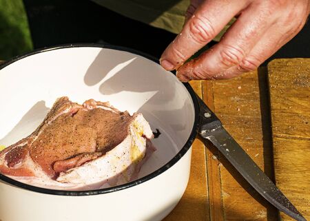 Cooking pork meat for barbecue. Pork with olive oil and spices. Raw pork steaks. Marinating meat.の写真素材