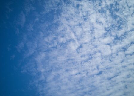Beautiful white cirrus clouds on a blue sky. Autumn sky and good weather. Background.の写真素材