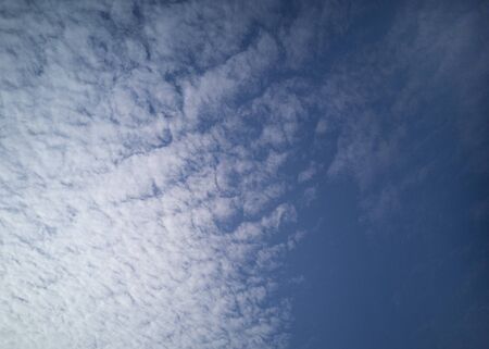 Beautiful white cirrus clouds on a blue sky. Autumn sky and good weather. Background.の写真素材