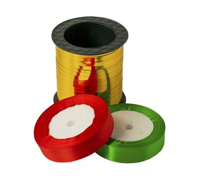 Roll of satin ribbon for decorating gifts on a white background. Silk and satin ribbon of gold, red and green.の写真素材