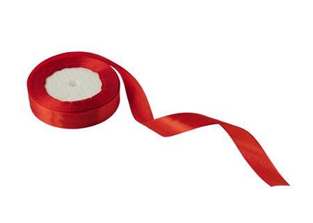 Roll of satin ribbon for decorating gifts on a white background. Silk and satin ribbon of red color.の写真素材