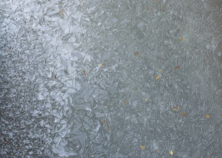 The texture of frozen water. Pattern of ice. Frost froze the river in winter. The surface of the lake. Cold weather.の写真素材