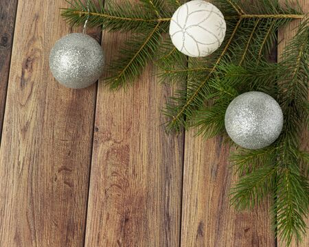 Decoration for christmas on a wooden background. Christmas tree branch and balls for the Christmas tree. New Year celebration. Copyspace.の写真素材
