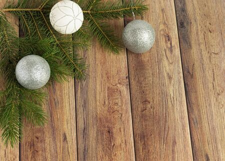 Decoration for christmas on a wooden background. Christmas tree branch and balls for the Christmas tree. New Year celebration. Copyspace.の写真素材
