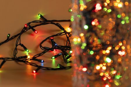 Colorful Christmas multicolored garland lights in a glass jar. Christmas light with copyspace for...
