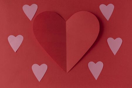 Red paper heart on a red background. Valentine's Day. Valentine's Day. Love and heart.