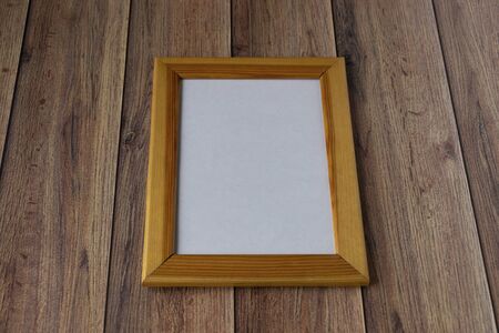 Valentine's day background. Photo frame, gift, heart and red satin ribbon on a wooden background. Valentine's Day, Mother's Day.の写真素材