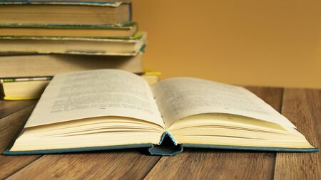 A stack of old books with yellow pages. Book binding. Knowledge and education. Literature in the library.の写真素材