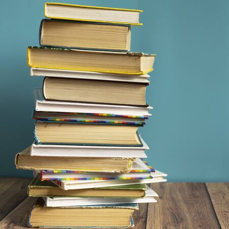 A stack of old books with yellow pages. Book binding. Knowledge and education. Literature in the library.の写真素材