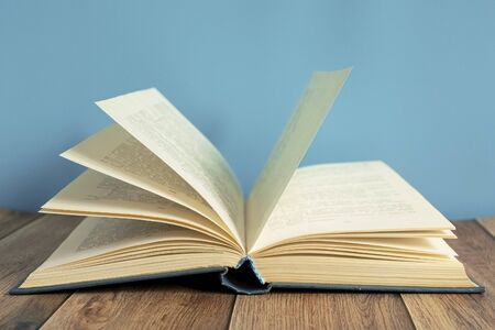 Open book. A stack of old books with yellow pages. Book binding. Knowledge and education. Literature in the library.の写真素材