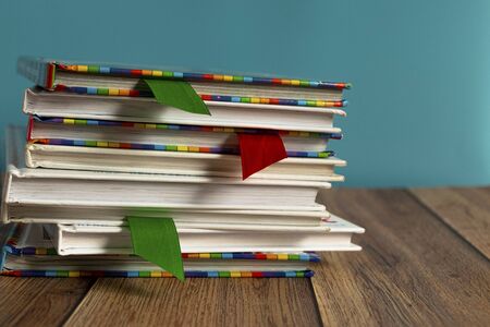 A stack of different bookmarks with bookmarks for pages. Book binding. Knowledge and education. Literature in the library.の写真素材