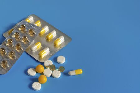 Coronavirus. Pills on a blue background. Personal protective equipment. Medication vaccine and...
