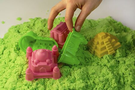 Kinetic sand. A child plays with kinetic sand. Fine motor skills, creativity, games.の写真素材