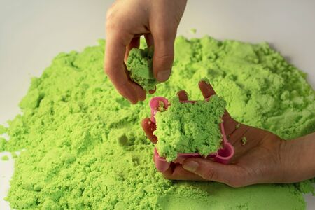 Kinetic sand. A child plays with kinetic sand. Fine motor skills, creativity, games.の写真素材