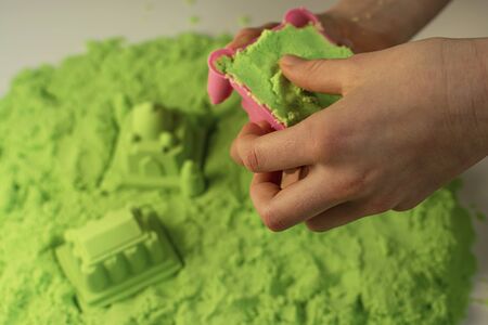 Kinetic sand. A child plays with kinetic sand. Fine motor skills, creativity, games.の写真素材