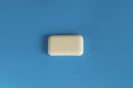 Soap on a blue background. Hygiene and cleanliness. Soap for bath, laundry and body care. Personal...