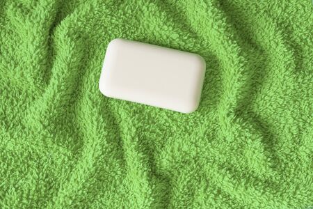 Soft and fluffy towels on a blue background. Soap for bath, laundry and body care. Personal hygiene products. Bath amenities, spaの写真素材