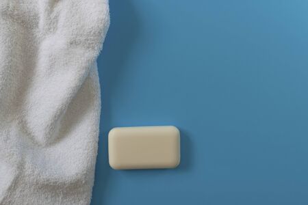 Soft and fluffy towels on a blue background. Soap for bath, laundry and body care. Personal hygiene products. Bath amenities, spaの写真素材