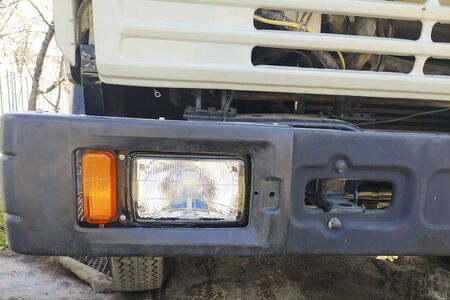 Different parts of a big truck. Headlight and bumper. Car repairの写真素材