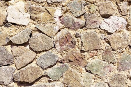 Background of stone wall. The texture and surface of the stoneの写真素材