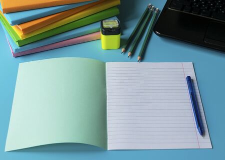 Distance Learning Concept. Pile of books, notebook, pencil, mobile phone. Student desk on online learning.の写真素材
