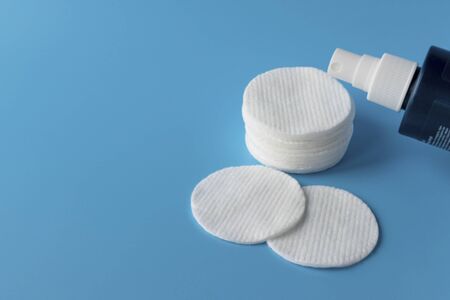 Cotton pads for skin care, for cleansing the face of cosmetics with tonic or micellar cleansing water. Cosmetic productsの写真素材
