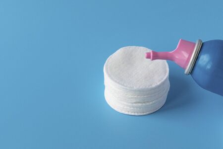 Cotton pads for skin care, for cleansing the face of cosmetics with tonic or micellar cleansing water. Cosmetic productsの写真素材