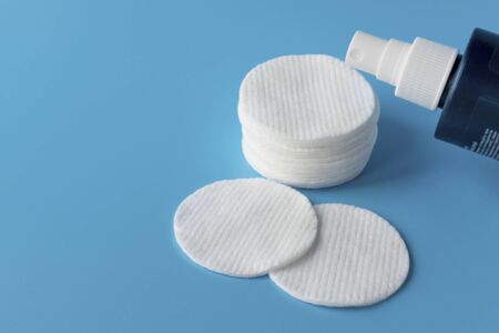 Cotton pads for skin care, for cleansing the face of cosmetics with tonic or micellar cleansing water. Cosmetic productsの写真素材