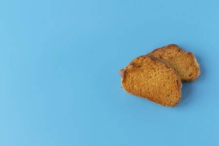 Crispy cracker on a blue background. Salty tea biscuits. Healthy Diet Snack.の写真素材