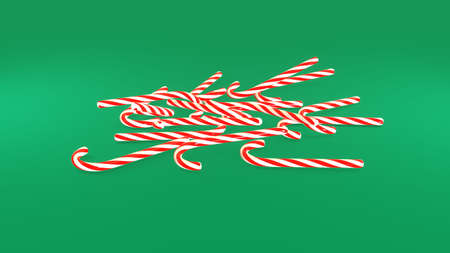 3D Render. Peppermint candy canes falling down slowly on green background. Candy cane caramels fall spin and rotate. Xmas and New Year's holiday concertの写真素材