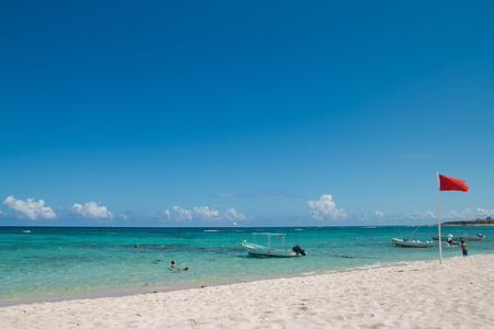 Quiet Caribbean Sea beach in Playa del Carmen, Yucatan, Mexico. Red flag.Lifesaver
の写真素材