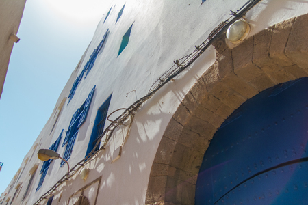 Typical walls of houses with blue windows in the old arabic town of Essaouira, Morocco, Africaの写真素材