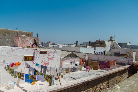 View over the roofs of houses with different clothes  after washing in the old arabic town of Essaouira, Morocco, Africa
の写真素材