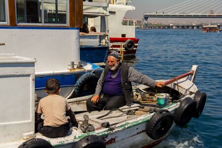 fishing boat on the Bosporus,surrounded by seagulls in Turkeyのeditorial素材