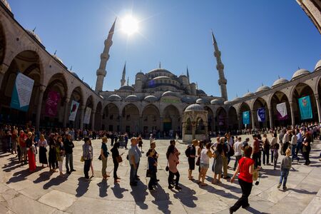Tourists visit in the Blue Mosque Sultanahmet. Long queue of people for ticket.