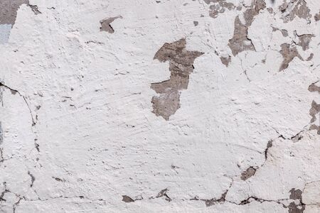 Cracked concrete texture background. Grey surface with cracks close up. Cracked grey old wall as...