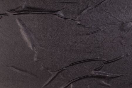 Black empty crumpled and wet texture paper. Creased grunge paper background. Art rough stylized blank for a billboard, poster or banner with space for text. Copy space.の写真素材