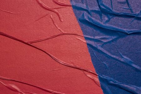 Empty crumpled and wet texture paper. Creased grunge paper background. Art rough stylized blank for a billboard, poster or banner with space for text. Copy space. Collage of red and blue.の写真素材