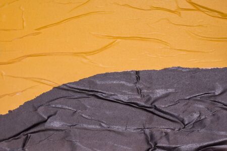 Empty crumpled and wet texture paper. Creased grunge paper background. Art rough stylized blank for a billboard, poster or banner with space for text. Copy space. Collage of yellow and black.の写真素材