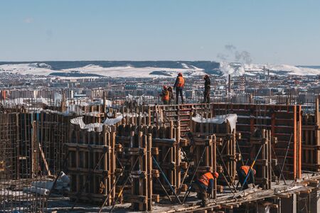 Construction site with crane with blue sky background.Construction of a multi-storey building in the...