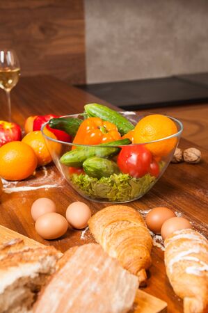 Dish with salad on wooden kitchen tableの写真素材