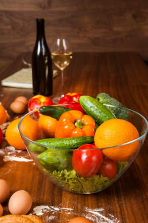 Dish with salad on wooden kitchen tableの写真素材